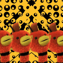 a row of stuffed animals are lined up on a yellow and black background