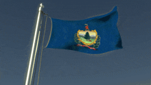 a flag that says ' vermont ' on it is flying in the wind