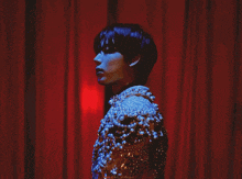 a man is wearing a jacket with pearls and beads on it