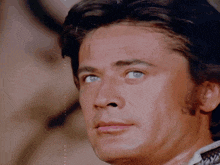 a close up of a man with blue eyes