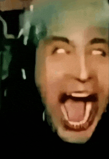 a close up of a person 's face with their mouth open .