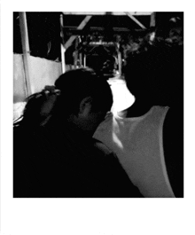a black and white photo of a man kissing a woman on the neck