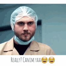 a man wearing a plastic cap and a surgical mask says " really canim yaa "