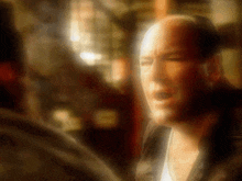 a blurry picture of a man 's face with his eyes closed
