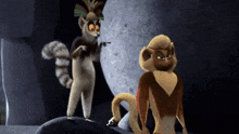 a lemur and a monkey are standing next to each other in front of the moon