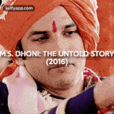 a close up of a man wearing a turban with the words m.s. dhoni : the untold story 2016