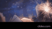 a person is holding a sparkler in front of a clipeo.com advertisement