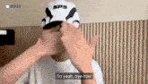 a man wearing a sps hat is saying so yeah bye-bye