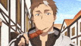 a man is eating a piece of meat on a stick in front of a building