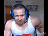a man wearing headphones and a white tank top that says ' supreme ' on it