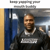 a man wearing an ultimate fighter shirt is standing in a hallway