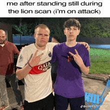 a man wearing a qatar airways shirt stands next to another man