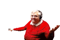an elderly man wearing headphones and a red sweater is making a funny face .