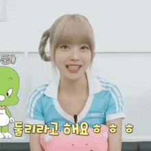 a girl in a blue adidas shirt is smiling in front of a green dinosaur