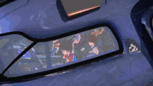 a boy in a red shirt is holding a remote control