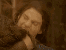 a close up of a woman with her mouth open being held by another woman .