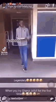 a man is holding a plate of food in his hand while walking in a doorway .