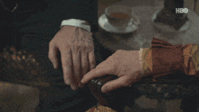 a man and a woman holding hands with hbo written on the bottom