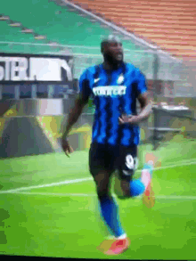 a soccer player with the number 8 on his jersey is kicking a ball
