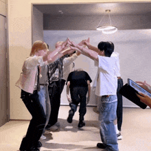 a group of people are giving each other high fives