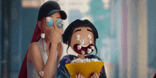 two cartoon characters are eating popcorn and one has a bowl of popcorn in her mouth .