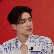a man wearing a blue and white shirt with a microphone