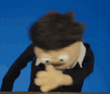 a puppet is making a funny face and pointing at something
