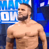 a man without a shirt is standing in front of a sign that says mack down