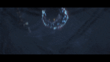 a dark background with a few lights floating in it