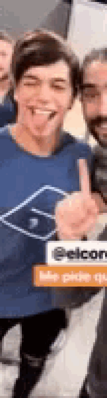 a man wearing a blue shirt is giving a thumbs up .