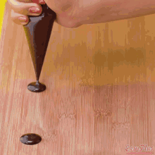 a wooden cutting board with easy plus written on the bottom right corner