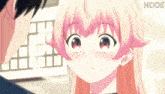 a girl with pink hair is looking at a man with a ndds logo behind her