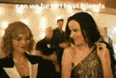 two women are standing next to each other in a room and smiling at each other .