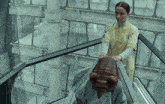a woman in a yellow uniform is standing next to a strange creature with the word kepler in the corner