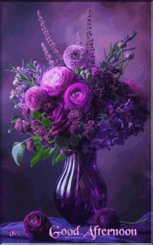 a bouquet of purple flowers in a purple vase with the words good afternoon below it