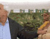 an older man stands in front of a sign that says 690