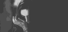 a black and white photo of a woman crying and smiling .