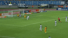 two soccer players celebrate a goal in front of a sign that says ' apostale '