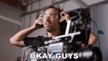 a man wearing headphones says okay guys