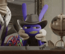 a purple bunny wearing a cowboy hat is sitting on a table .
