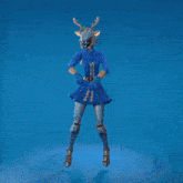 a woman in a blue dress with antlers on her head is dancing with her arms in the air