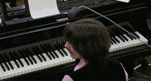 a person playing a piano that has the word blum on the keys