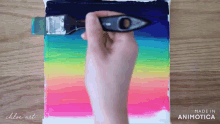 a person is painting a rainbow on a canvas with a brush made in animotica