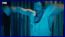 a man wearing headphones and a shirt that says fox is dancing