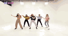a group of women are dancing in front of a white background with the show written on the bottom