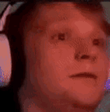 a man wearing headphones is making a funny face .