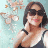 a woman wearing sunglasses stands in front of a painting of butterflies