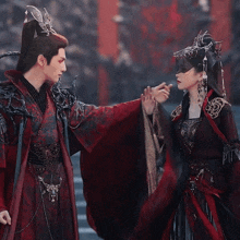 a man and a woman are standing next to each other