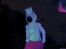 a person is standing in a dark room with a pink cloth hanging from their waist .
