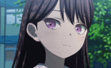 a girl with long dark hair and purple eyes looks at the camera